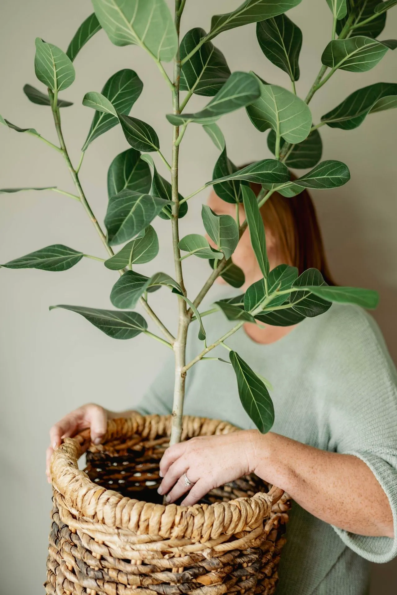 Kelsey holding a plant in a basket